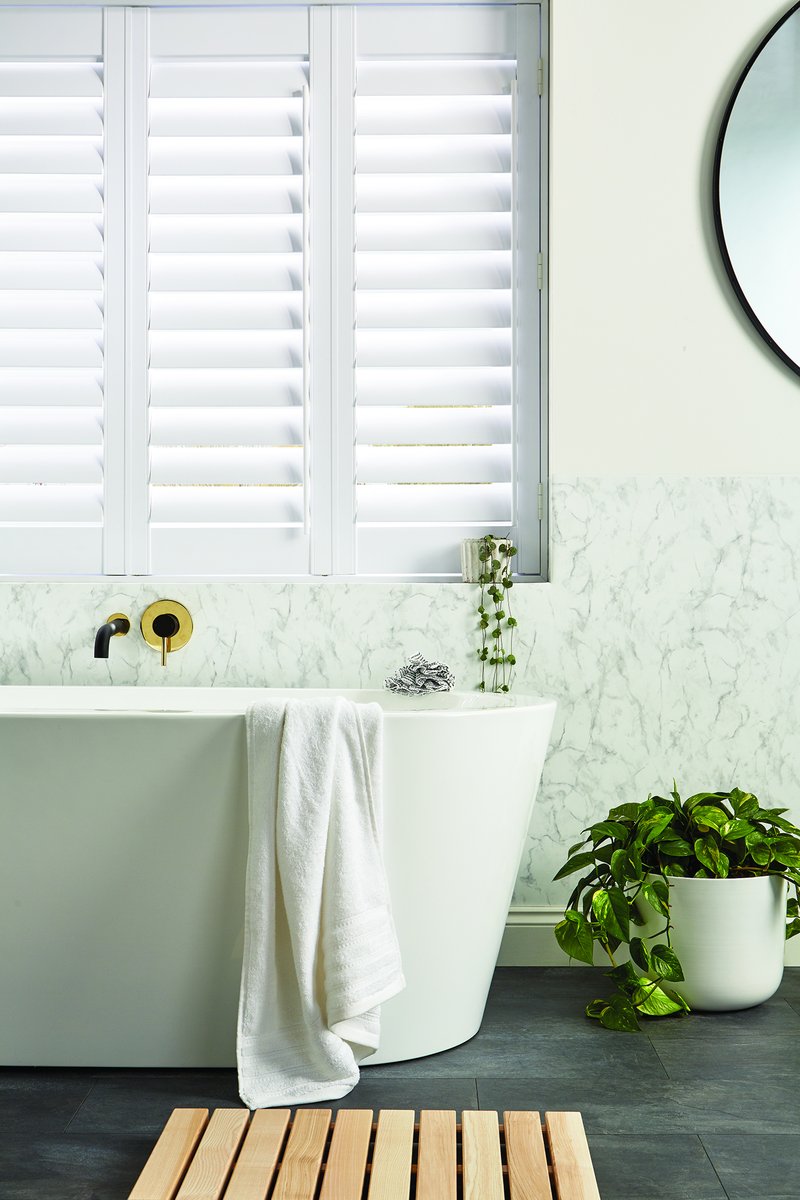 Classic white shutters in traditional bay window